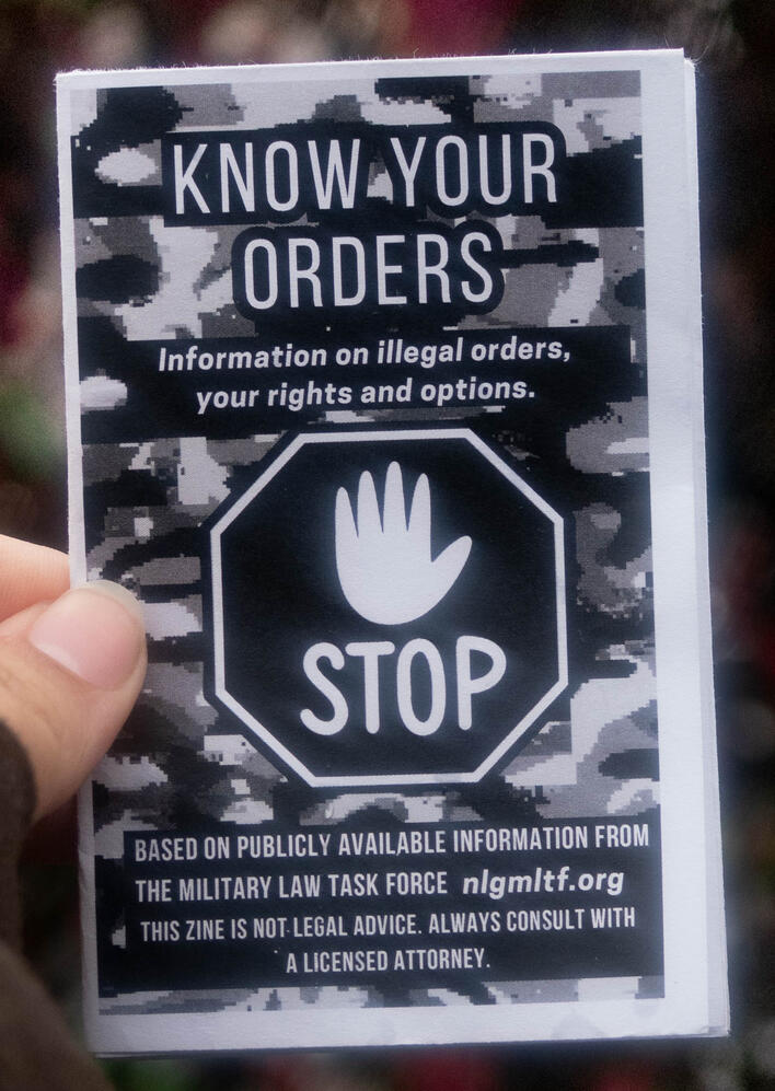 Untitled A photo of a zine cover depicting a stop sign on a camo background. This zine is titled "Know Your Orders"